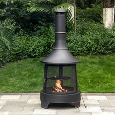 an outdoor fire pit sitting on top of a brick patio