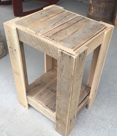 a small wooden table sitting on top of a cement floor