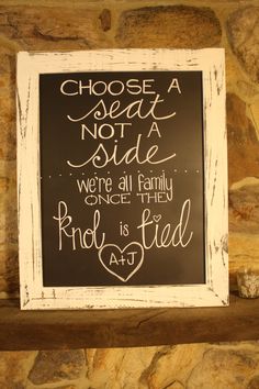 a sign that is on the side of a stone wall saying choose a seat not a side, we're all family once they rhode is tied together