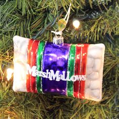 an ornament hanging from a christmas tree with marshmallows on it