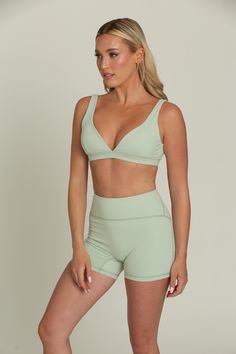 Our Pastel Green Bralette will be your go-to for everyday comfort. This plunging V-cut neckline bralette features removable padding for customizable support and is hardware-free for a seamless fit. Crafted from buttery soft fabric, it offers a luxurious feel against your skin. Perfect for lounging or layering, this comfortable and stylish bralette will quickly become a staple in your wardrobe. Green Bralette, Yoga Gym, Long Crop Top, Pastel Green, V Cut, V Cuts, Skirt Leggings, Trending Now, Cropped Tank Top