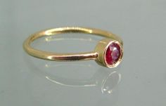 Elegant Ruby Stackable Rings With Bezel Setting, Classic Ruby Stackable Rings With Gemstones, Classic Ruby Gemstone Stackable Rings, Bezel-set Round Cut Ruby Ring, Ruby Ring With Bezel Setting, Round Cut, Minimalist Gold Ruby Ring With Bezel Setting, Yellow Gold Ruby Birthstone Ring With Bezel Setting, Gold Stackable Ruby Ring, Gold Stackable Rings With Ruby Bezel Setting