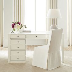 a white desk and chair with flowers on it