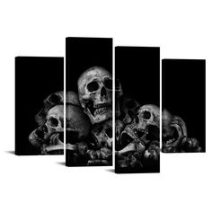 black and white photograph of three skulls with one skull in the middle, against a dark background