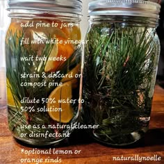 two mason jars filled with lemons and rosemary