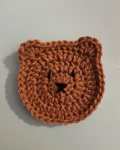 a crocheted bear head on a white surface