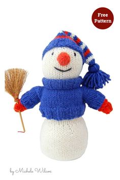 a knitted snowman is holding a broom