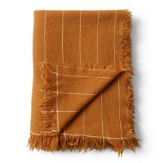 an orange and white blanket with fringes