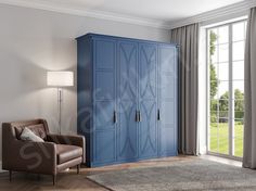 a living room with a blue armoire next to a brown chair