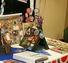 the table has many badges on it and is ready to be used as a display