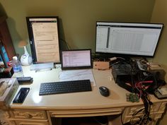 a desk with two computer monitors, keyboard and mouse on it in front of a monitor