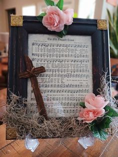 a wooden frame with flowers and a cross