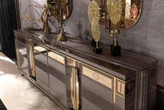 an art deco sideboard with mirrors and vases