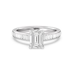 a white gold engagement ring with an emerald cut diamond in the center and side stones