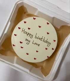 a birthday cake in a plastic container with the words happy birthday my love written on it