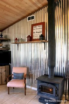 a living room with a stove and chair