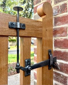 a close up of a wooden gate with metal latches on the side of it