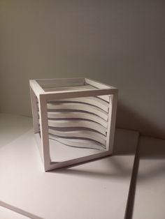 a sculpture made out of white paper sitting on top of a table