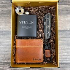 the grooms gift box includes a flask, leather wallet, and personalized flask opener