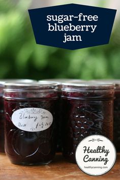 three jars of blueberry jam sitting on top of a wooden table with the words sugar - free blueberry jam above them