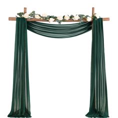 a green and white wedding arch with flowers on the top, hanging from a wooden pole