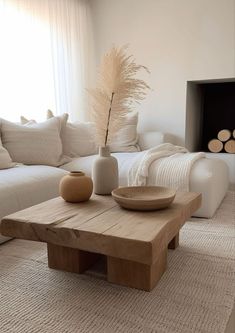 a living room filled with furniture and a fire place in front of a white couch