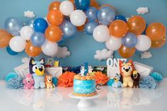 a birthday cake and balloons on a table