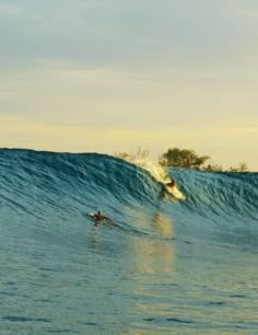 two surfers are riding the waves in the ocean