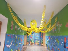 the hallway is decorated with yellow paper streamers and under - water toys for decoration