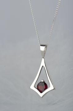 Are you looking for dainty jewelry for a person who likes minimalist design? Here is a garnet necklace in a geometric shape - subtle but still noticeable because of beautiful deep red color of the stone. It can be a gift for many occasions - especially for birthday, because garnet is January birthstone (and also Capricorn stone). In my workshop I have also garnets in other colors - pink rhodolite and orange spessartine. If you wish me to set one of them instead of red bohemian garnet please cont Handwritten Jewelry, Metalsmithing Jewelry, Stacked Necklaces, Silver Jewelry Design, Garnet Necklace, January Birthstone, Silver Jewelry Handmade, Amulets, Sterling Silver Necklace Pendants