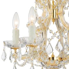 a gold chandelier with crystal drops hanging from it