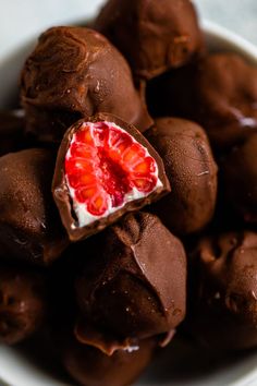 a white bowl filled with chocolate covered strawberries