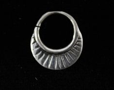 a small silver ring on a black background