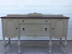 an old dresser is painted white and brown