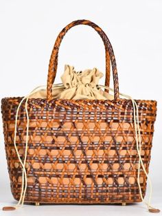 Casual style. Lightweight. Straw. Raffia natural fiber. Lined. Drawstring. Metal bottom accesories. Measurements are 24 cms. Length (9.44” inches) x 20cms height (7.87” inches) x 12 cms width (5" inches) Color may be lighter or darker depending of the device it is displayed. Casual Light Brown Woven Straw Bag, Casual Brown Basket Straw Bag, Light Brown Woven Vacation Bag, Light Brown Woven Bags For Vacation, Chic Natural Fiber Shoulder Bag With Bamboo Handle, Casual Jute Straw Bag With Bamboo Handle, Chic Jute Straw Bag With Woven Leather, Chic Straw Bag With Woven Leather Details, Woven Light Brown Bags For Vacation