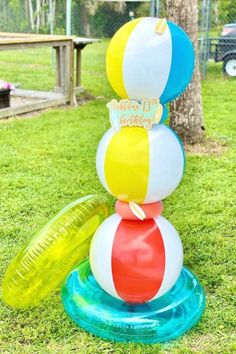 an inflatable beach ball is stacked on top of another inflatable toy