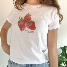 Cottagecore aesthetic baby tee with strawberry graphic 🍓 comes in two versatile colors - a trendy 2000's top to add to your closet! ✦ Sizing The baby tee is a shorter, more feminine fit inspired by 90s & Y2K fashion. It is similar to a crop top, but not as tight-fitting. We recommend measuring your favourite baby tee or singlet at home to find the right size for you. Model wears size: XS SIZE CHART (INCHES) XS: 16.14 width, 20.47 length S: 16.93 width, 22.05 length M: 18.11 width, 23.62 length Strawberry Y2k, Baby Tees 90s, Kawaii Cottagecore, Clothing Coquette, 90s Crop Top, 2000s Tops, Coquette Shirt, Summer Crop Top, Quoi Porter