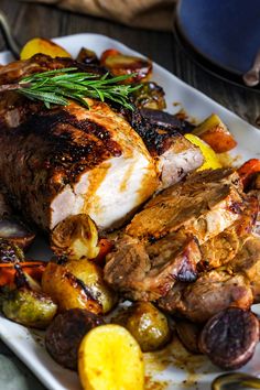 a white plate topped with meat and veggies