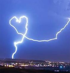 a lightning bolt is seen in the sky over a city