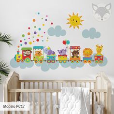 a baby's room with a wall decal that has animals on the train