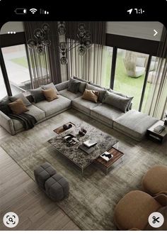 an aerial view of a living room with couches, tables and chairs in it