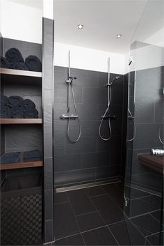 a walk in shower sitting inside of a bathroom