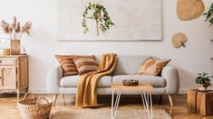 a living room filled with furniture and decor on top of hard wood floored floors