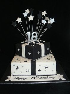 a black and white birthday cake with stars on the top that says happy 18th birthday