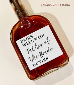 a bottle of wine with a label on it that says, pairs well with father of the bride duties