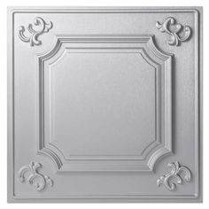 a ceiling tile with an ornate design on the top and bottom, in silver color