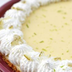 a close up of a pie with white frosting