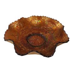 a brown glass bowl sitting on top of a table