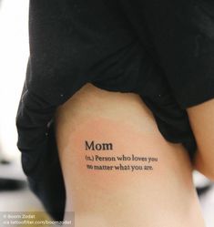 a woman's stomach with the words mom written on her lower back and upper thigh