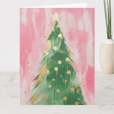 a card with a christmas tree painted on it